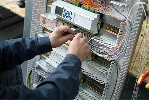 CML team member wiring automation and control system.