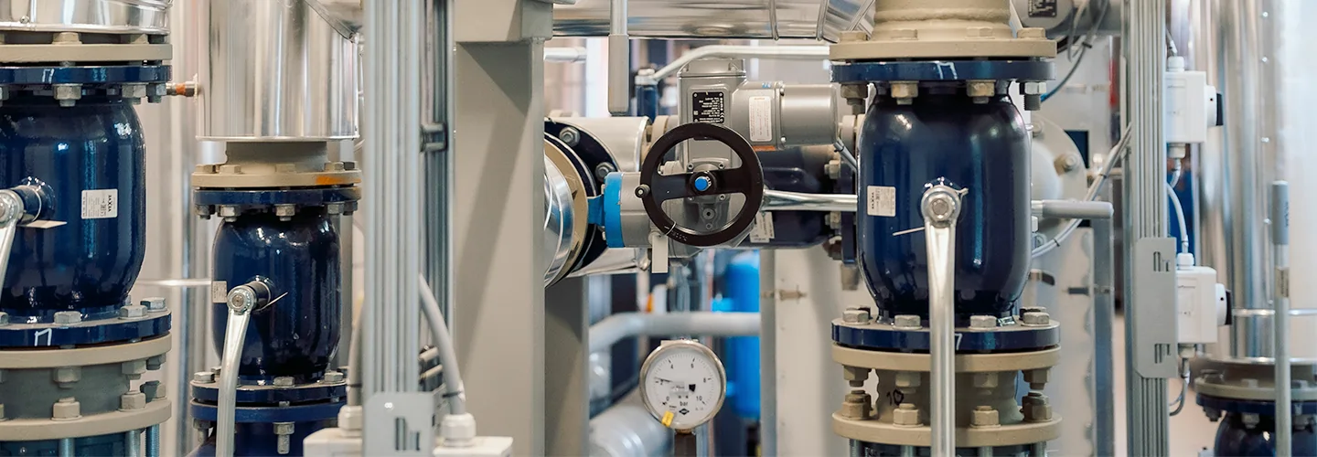 Industrial piping system with valves and gauges in a facility.